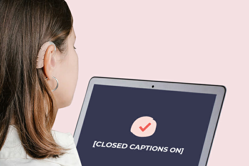 image showing a woman with a hearing aid watching a video with closed captions