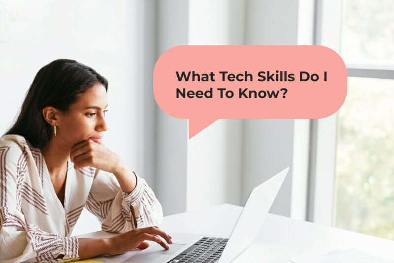 Woman typing on laptop in a white room on a white desk, asking what tech skills does she need to know